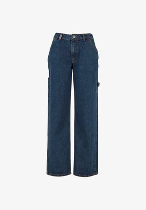 Tume sinised teksapüksid kõrge vöökohaga, laiade sääreosade ja küljetaskutega. Omavad nähtavat õmblustööd ja metallist detailidega aksentideid.