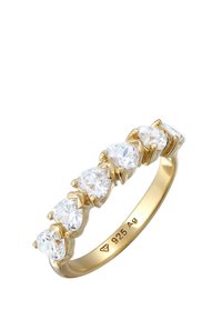 Bague dorée ornée de six pierres claires en forme de poire serties dans des griffes, avec un anneau lisse affichant des gravures à l'intérieur.