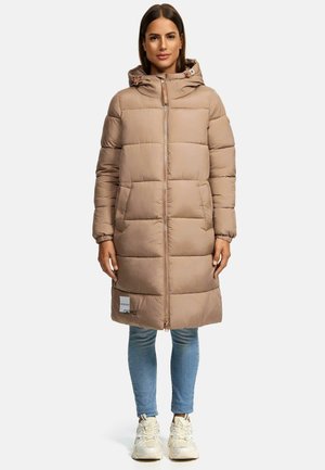 Beige Pufferjacke mit Kapuze, gestepptem Design und Frontreißverschluss. Verfügt über ein Logopatch und gerippte Bündchen. Getragen über blauen Jeans und Sneakers.