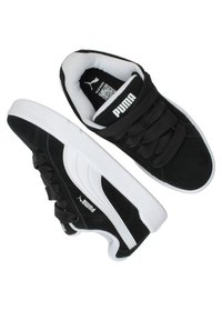 Sneaker nere in suede con dettagli bianchi, lacci piatti e suola testurizzata, con un logo Puma ben visibile sulla linguetta e sul lato.