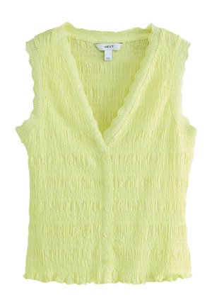 Vestă tricotată texturată fără mâneci, de culoare galben pal, cu decolteu în V cu margini ondulate și închidere cu nasturi pe față.