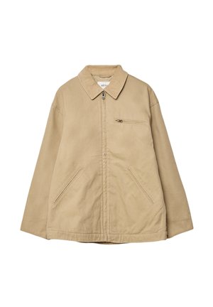 Beige Zip-Jacke mit Reißverschluss und einem Cordkragen, zwei Seitentaschen und einer Brusttasche. Hergestellt aus leichtem Stoff mit glatter Textur.