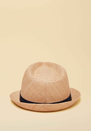 Light brown woven fedora hat with a black band around the base, set against a plain beige background.