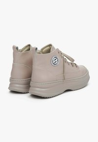 High-top sneakers in soft beige leather with a padded collar, tonal laces, round logo patch, and textured rubber sole.