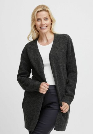 Dark gray knitted cardigan with an open front, long sleeves, and ribbed cuffs, worn over a white top and black pants. Soft texture.
