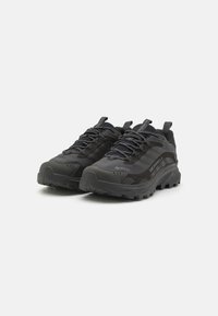 Black hiking shoes featuring synthetic material, textured surface, rubber sole, and a lace-up design with reflective accents.