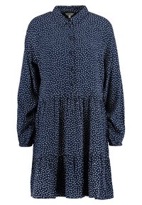 Abito button-up blu navy con un orlo a strati e volant, maniche a palloncino lunghe e un motivo di uccelli bianchi su tutto il tessuto. Tessuto leggero.