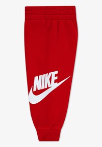 Rdeče športne hlače Nike z belim logotipom in dizajnom Swoosh. Elastičen pas in manšete, mehka tkanina. Enostavna, zožena silhueta.