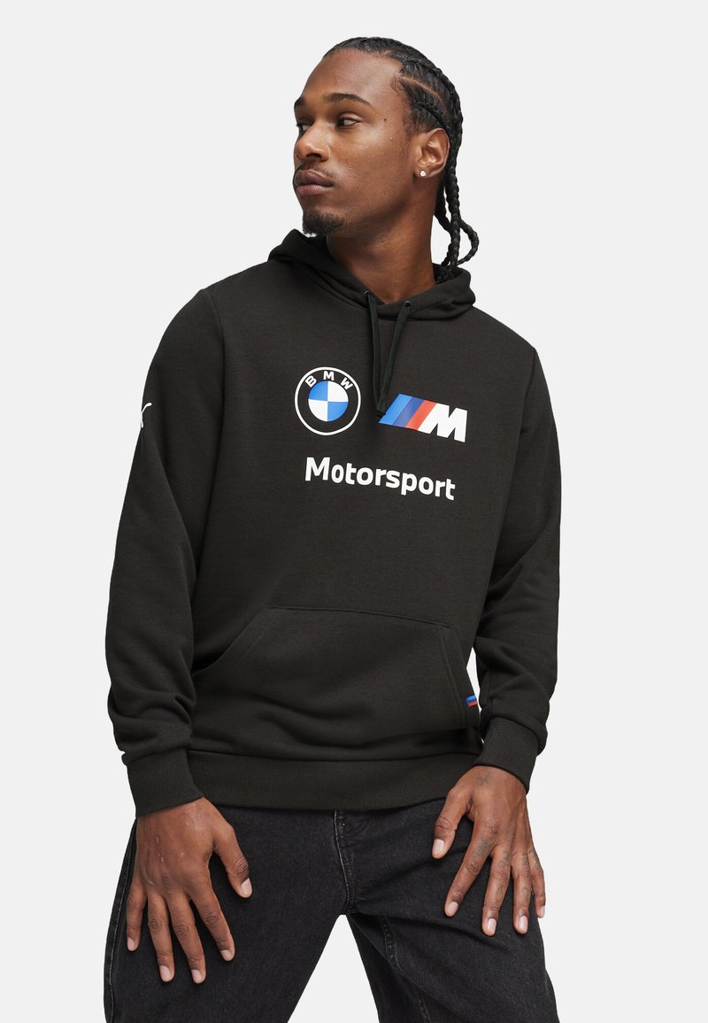 Black hoodie made of soft fabric, featuring a front pocket, drawstring hood, and graphics with BMW and M Motorsport logos in white and blue.
