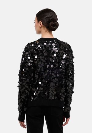 Pull noir couvert de grandes paillettes brillantes, avec un col rond et des poignets côtelés, doté d'une coupe décontractée et d'un ourlet uni noir.