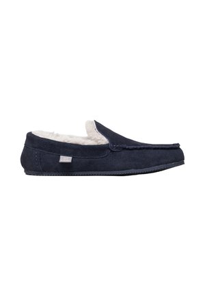 Men's navy blue suede moccasin slipper with white fleece lining and flexible sole, labeled "Lakeland" on the side.