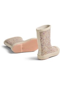 Bottes en caoutchouc à motif floral avec une base beige et une semelle rose. Présentent une surface texturée et rembourrée ainsi qu'un bord lisse autour de l'ouverture.
