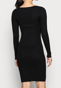 Abito aderente nero con maniche lunghe, design sagomato e scollatura rotonda, che presenta un motivo in maglia a trama.