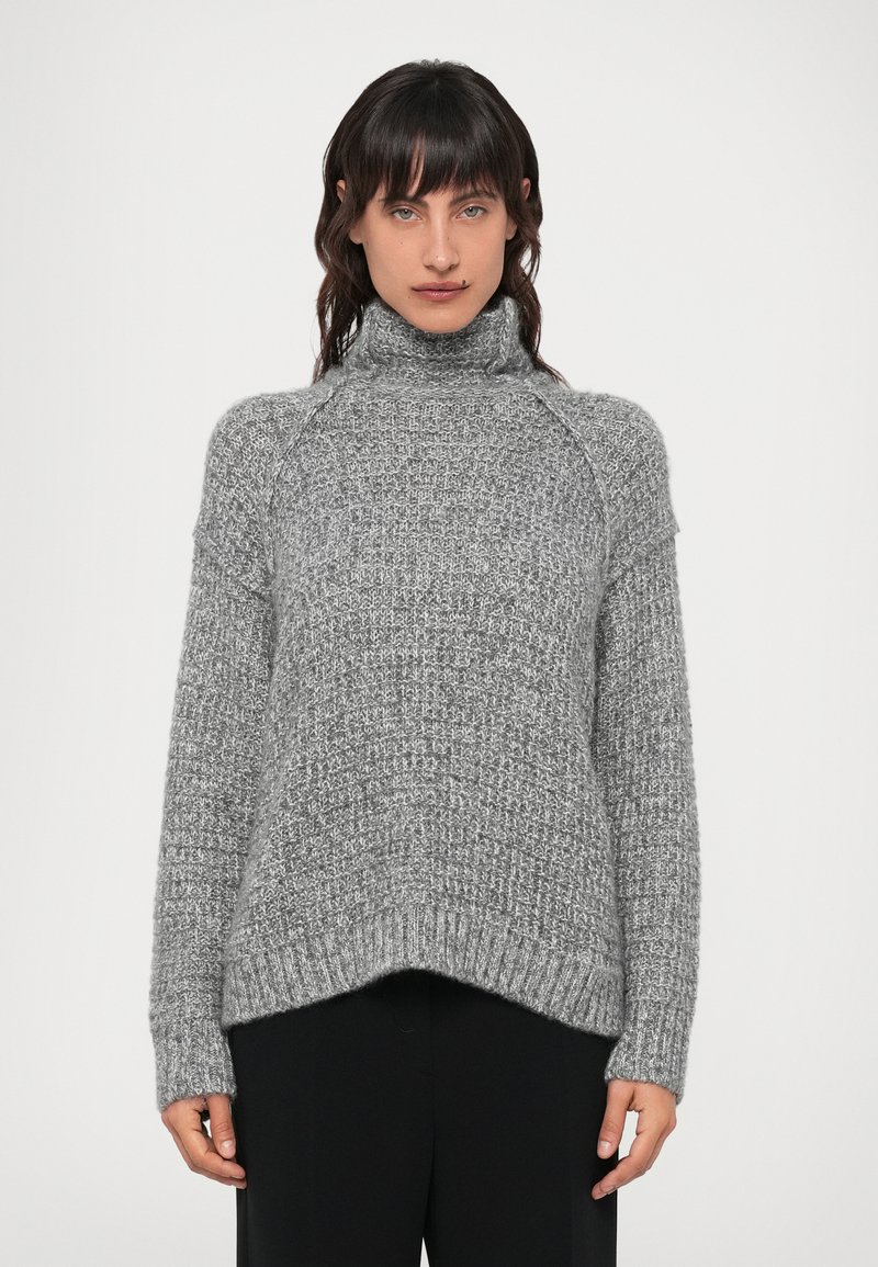 Suéter de punto gris, con un alto cuello de tortuga, puños y dobladillo acanalados, con un patrón texturizado en toda la prenda y una silueta oversized.
