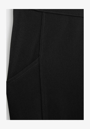 Black ribbed fabric featuring a side pocket with visible stitching, smooth texture, and a fitted design along the leg.