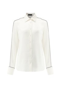 White long-sleeve shirt made of smooth fabric with a buttoned front and black piping along the shoulders and sleeve cuffs.