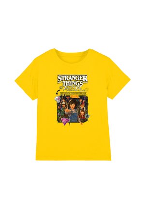 Yellow T-shirt featuring Stranger Things characters, text "Tales from '85" and "The Hawkins Investigators Club" with graphic elements and symbols.