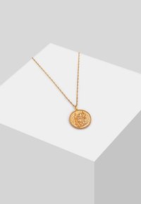 Collana dorata con catena testurizzata e un ciondolo tondo che presenta un design in rilievo di una figura e un bordo decorato.