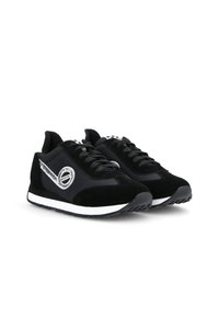 Black suede sneakers with a grey metallic accent, white midsole, and black laces. Features a rounded toe and textured surface for grip.