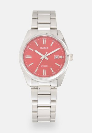 Silver stainless steel watch with a round red dial, black hour markers, silver hands, and a date display. Water-resistant up to 50 meters.