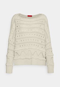 Pull en tricot crème à coupe décontractée, présentant des motifs ajourés et un ourlet côtelé. Manches longues avec bords roulés.