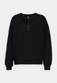 Sweatshirt nero con maniche lunghe, caratterizzato da un design in pizzo nero testurizzato lungo il colletto. Polsini e orlo a coste.