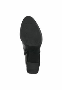 Bota de tobillo de cuero negro con tacón vista desde la suela, con un fondo texturizado antideslizante y tacón cuadrado.