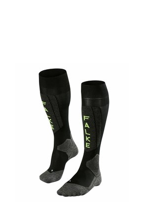 Calze nere al ginocchio con branding verde "FALKE". Realizzate in un mix di materiali, presentano una sezione inferiore testurizzata per una migliore aderenza e comfort.