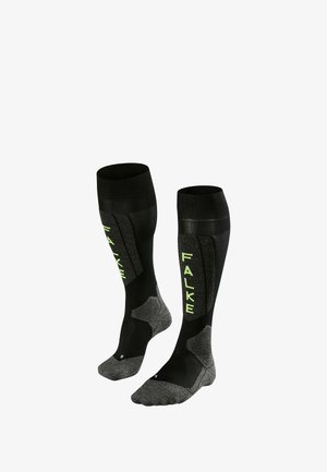 Schwarze knielange Socken mit grünem "FALKE"-Logo. Hergestellt aus einem Materialmix und mit einem strukturierten unteren Bereich für Grip und Komfort.