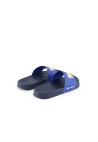 Blue rubber slide sandals with two wide straps. Features textured soles and bold yellow logo on the upper strap. Flat design, lightweight.
