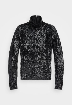 Sort turtleneck top dækket af tætsiddende perler. Har lange ærmer og en kvart-lynlås. Glat, reflekterende overflade.