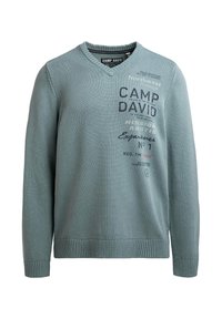 Türkisfarbener V-Ausschnitt-Pullover aus strukturiertem Strickstoff, mit verschiedenen Drucken und Logos in kontrastierenden Farben. Gerippte Bündchen und Saum.