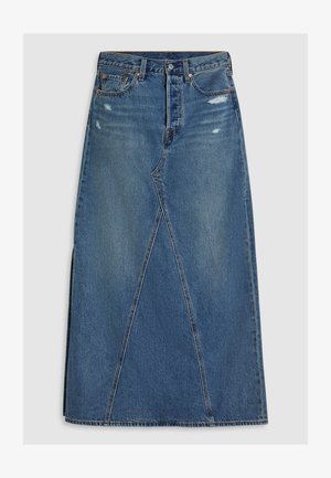 Denim maxi skirt in medium blue with faded sections, featuring a high waist, front pockets, and an angular design with a vent at the hem.