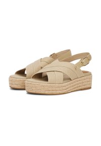 Beežid espadrillid, mis on ristlindi kujundusega, jute-kattega tald ja reguleeritav slingback kinnitusega. Pehme kangas.