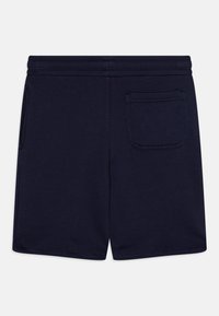 Marineblaue Shorts aus weichem Stoff, mit einer Gesäßtasche, elastischem Bund und einem schlichten Design ohne weitere Muster.
