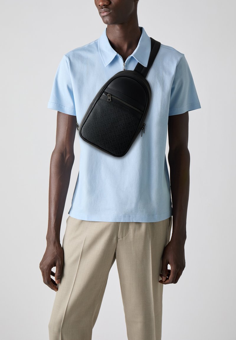Tommy Hilfiger MONOGRAM SLING BAG - Bum bag - black