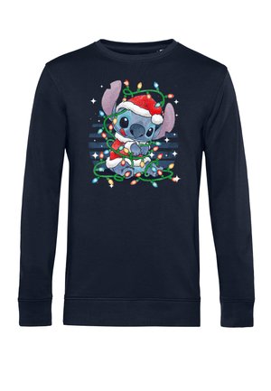 Sweatshirt marine avec un motif représentant un personnage portant un chapeau de Noël entouré de lumières colorées. Manches longues et col rond. Texture douce.