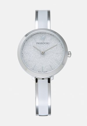 Silver metallic watch with a round face. Sparkling textured white dial, silver hands, and a sleek bracelet-style band. Swiss made.