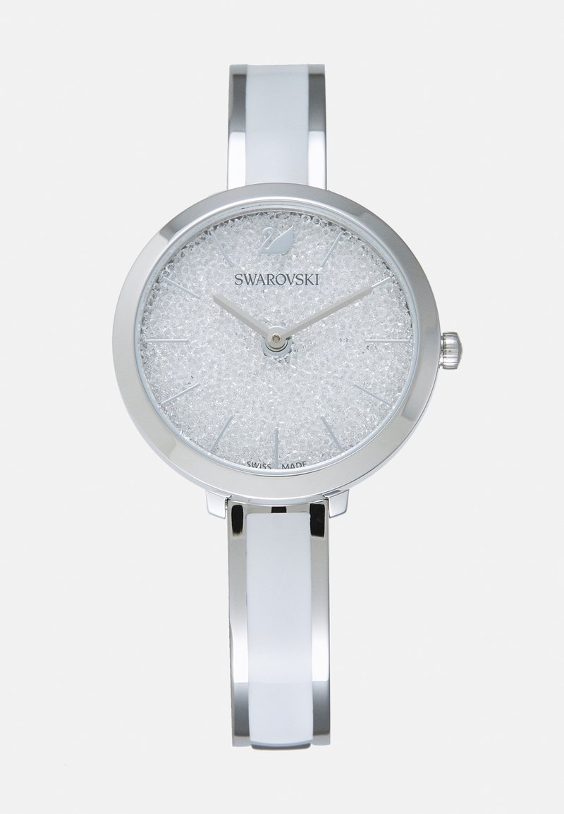 Orologio in metallo argentato con quadrante rotondo. Cassa bianca scintillante con texture, lancette argentate e un elegante bracciale. Fabbricato in Svizzera.