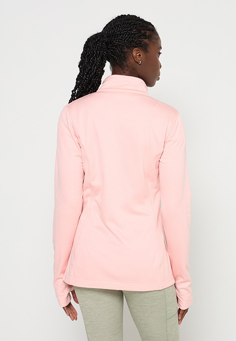 Chaqueta rosa claro con cremallera y manga larga, que presenta un tejido texturizado y un diseño ajustado. El cuello es alto y la parte trasera es lisa.