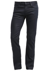 Mörkblå jeans, slim fit, tillverkade av en blandning av bomull. Har en femfickdesign, metallknapp och sömnadsdetaljer. Slät textur.