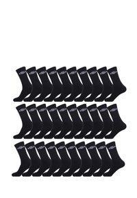 Chaussettes en coton noir disposées en grille, avec un logo blanc sur le revers. Texture douce et design mi-mollet.