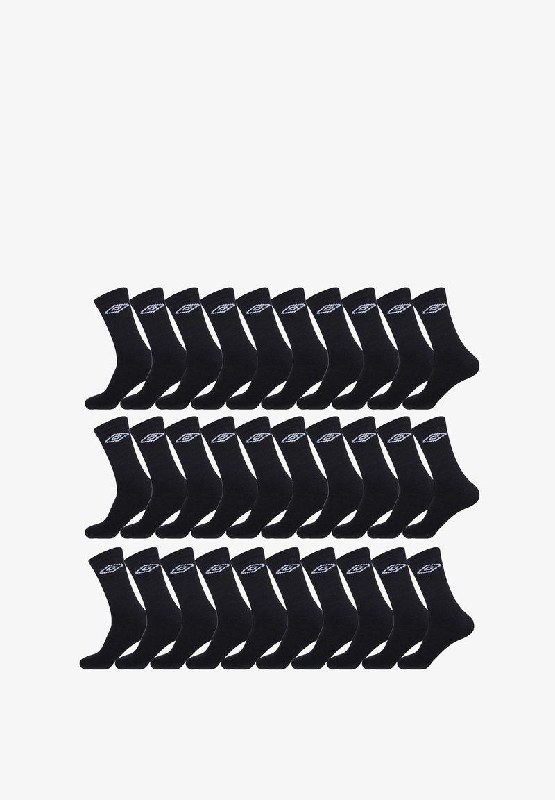 Chaussettes en coton noir disposées en grille, avec un logo blanc sur le revers. Texture douce et design mi-mollet.