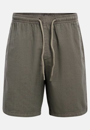 Σορτς με ελαστική μέση σε σκούρο ελιά χρώμα, με μπροστινό κορδόνι και πλαϊνές τσέπες, κατασκευασμένα από υφή ύφασμα.