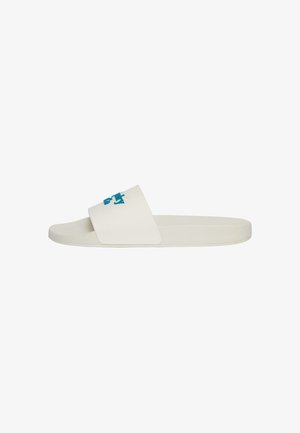 Enkele witte slidesandaal met een brede band met een turquoise logo op het bovenwerk, vlakke zool en gestructureerd voetbed.