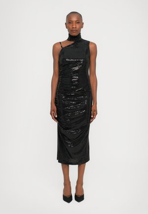 Black sequin dress with a fitted silhouette, asymmetrical neckline, and draped texture. Mid-calf length, paired with black pointed heels.