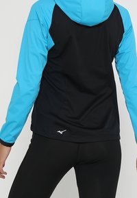 Hooded jacket featuring a blue and black color scheme, made from lightweight fabric with mesh panels for breathability and flexibility.