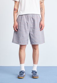 Lightweight, patterned shorts in pastel blue with subtle stripes; elastic waistband, knee-length, paired with dark shoes and white socks.