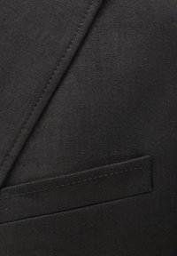 Black linen blazer fabric with a smooth texture, featuring a stitched lapel and a small, straight pocket detail.