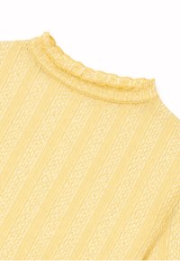 Top en maille côtelée jaune avec des rayures texturées florales et un col montant à volants.